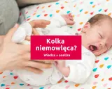Płacz dziecka, gdy dopada go kolka. Rodzic próbuje pomóc maluchowi.